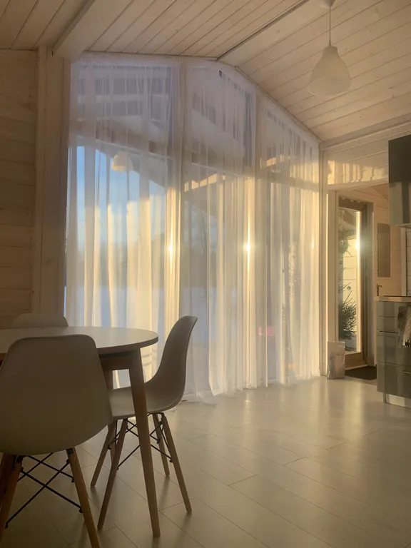 Дом с панорамными окнами в окружении леса