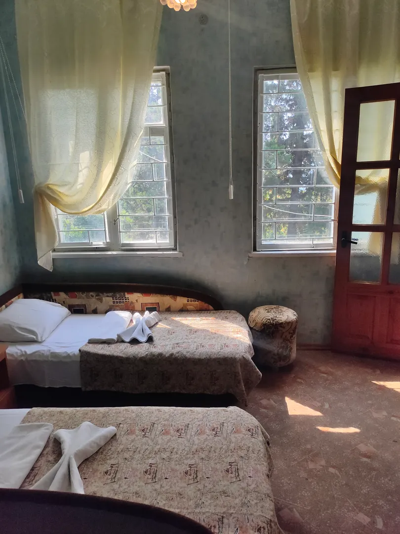 Фото 1 спальни, вид из окна на море. Мебель - 2  кровати-диван, пуфик, кресло, шифоньер, тумбочка, трюмо с зеркалом.