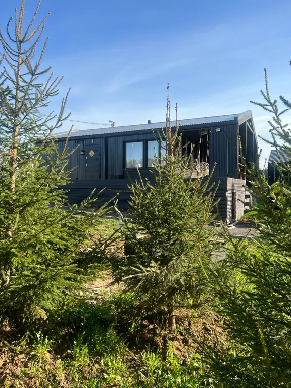 Современный дом с баней в лесу