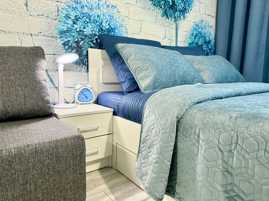 Уютная квартира-студия с большой кроватью и диваном