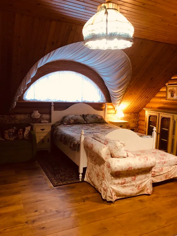 Изба (дом) из экологически чистого бревна под камышовой крышей в лесу