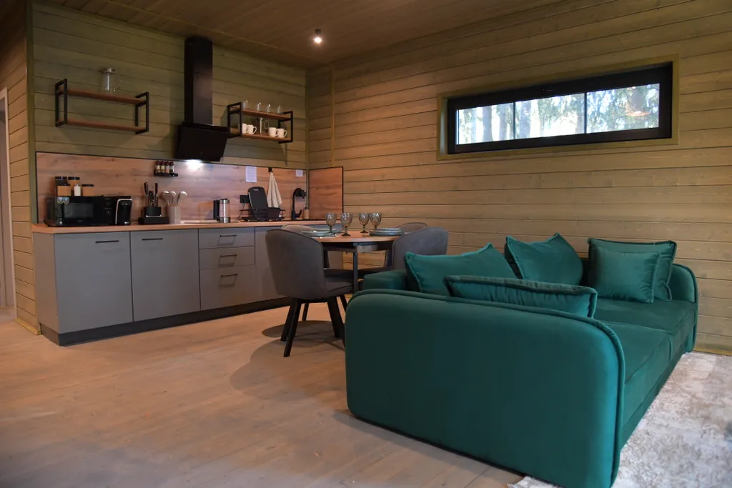 Дом с панорамными окнами в чаще леса у берега реки