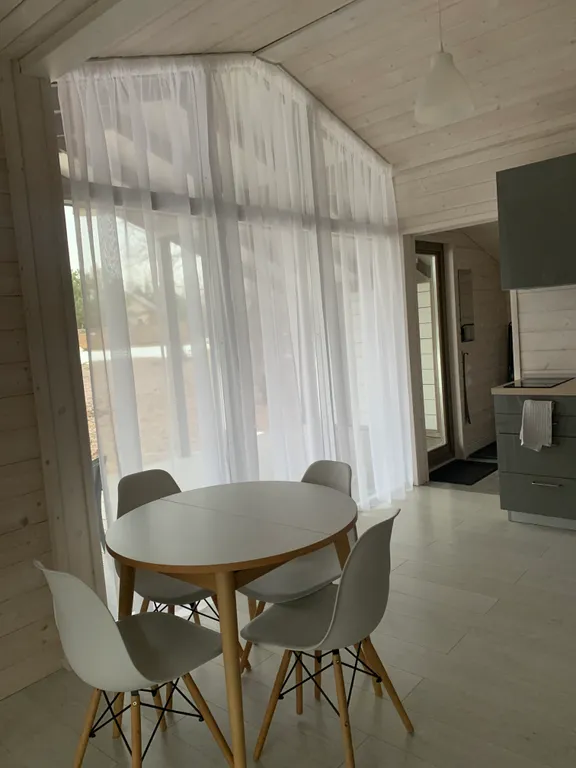 Дом с панорамными окнами в окружении леса