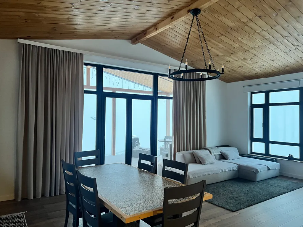 Домик на холме с видом на лес и горы