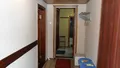 Прихожая и коридор. В коридоре гладильная доска и утюг, платяной шкаф
