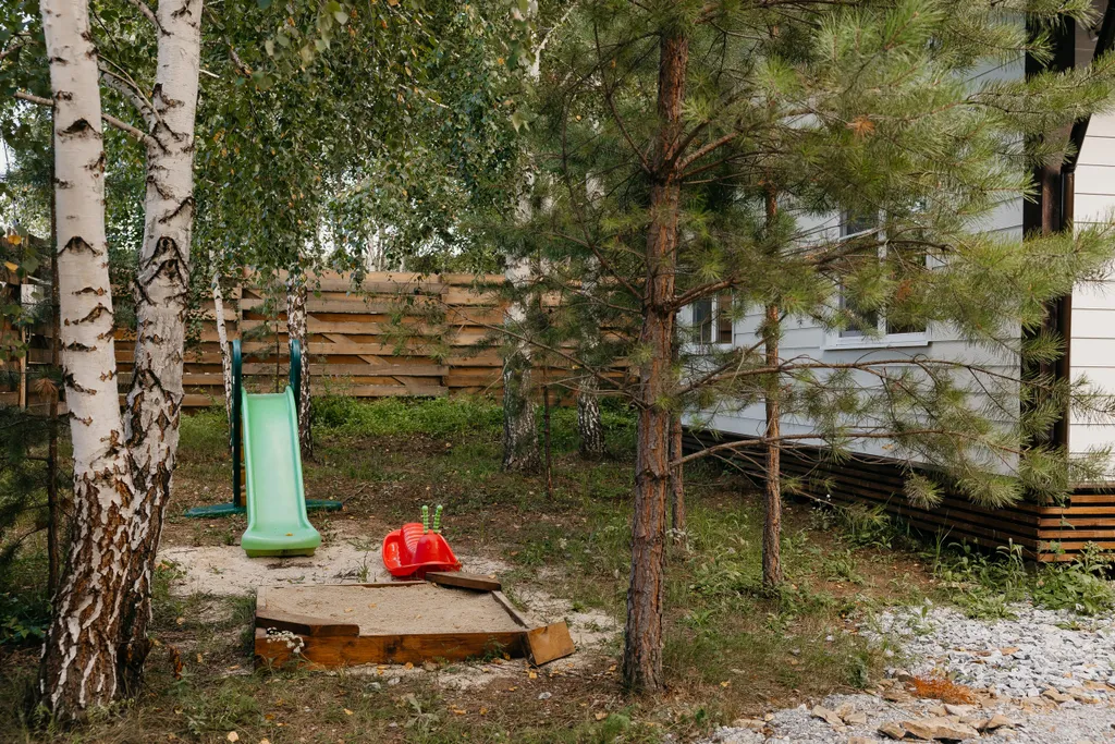 Дом с панорамными окнами и террасой в окружении леса