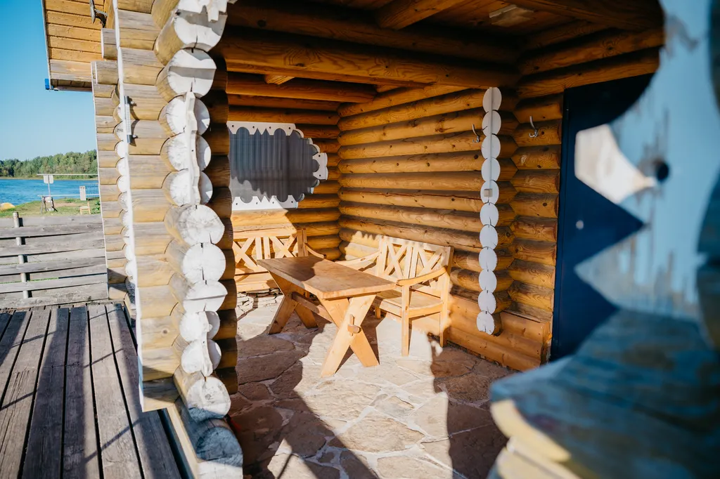 Уютный деревянный домик на берегу пруда с баней