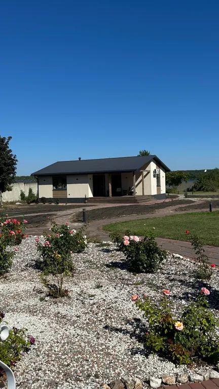 Дом-баня в красивом саду рядом с водоемом