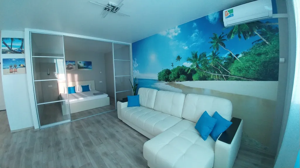 Светлая квартира- студия в голубых тонах с красивым видом на город