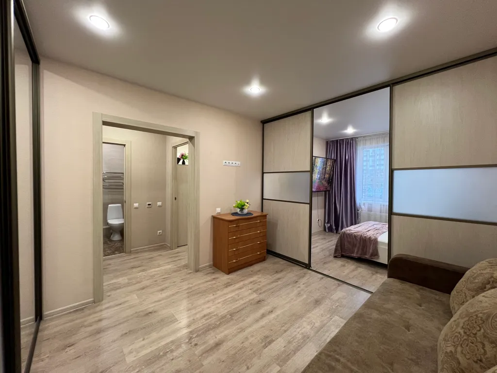 Дизайнерская квартира с огромным телевизором напротив кровати