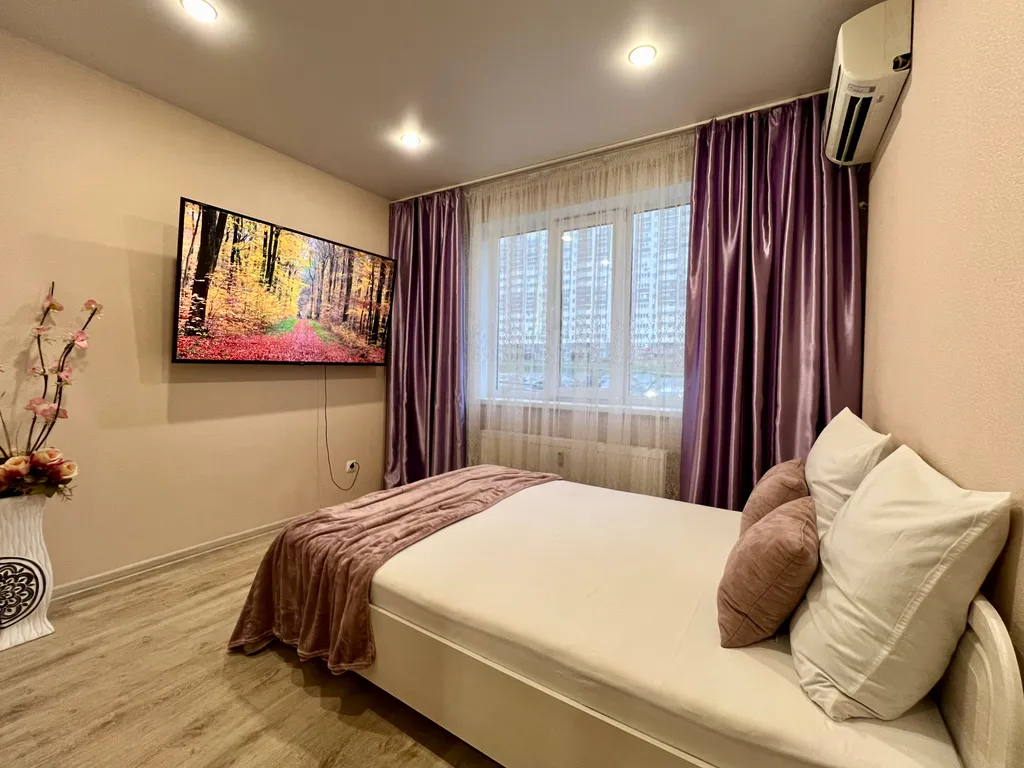 Дизайнерская квартира с огромным телевизором напротив кровати