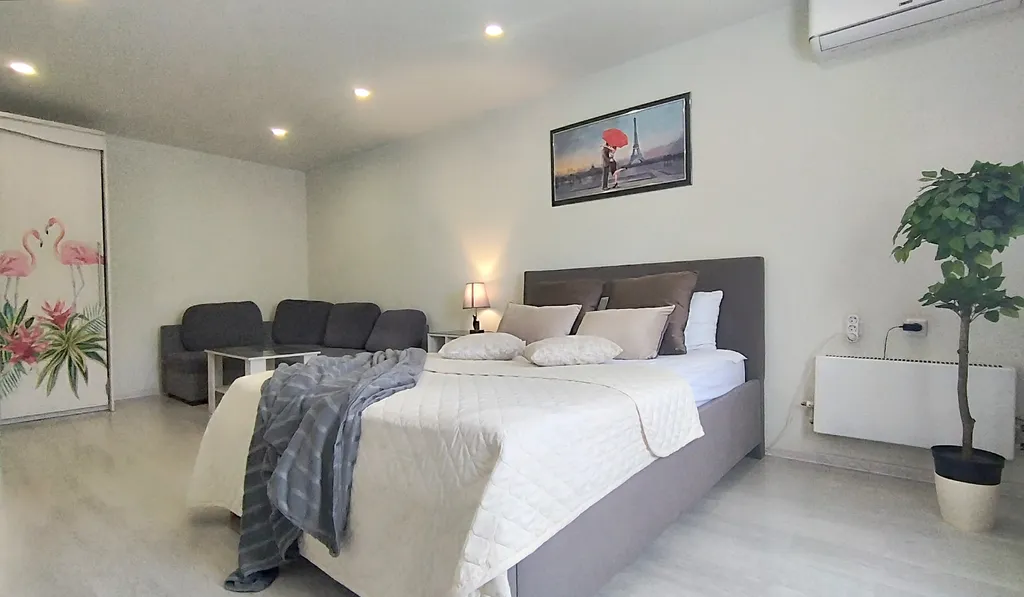 Уютная квартира в стиле лофт с комфортной кроватью и угловым диваном