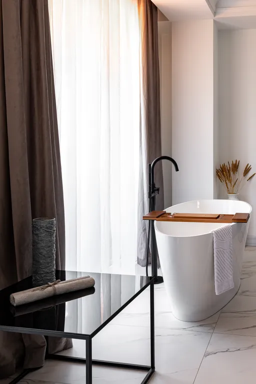 Стильная студия с ванной у панорамного окна и видом на горы