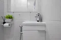 В туалетной комнате есть раковина с зеркалом, гигиенический душ, туалетная бумага, мыло для рук, тёплый пол