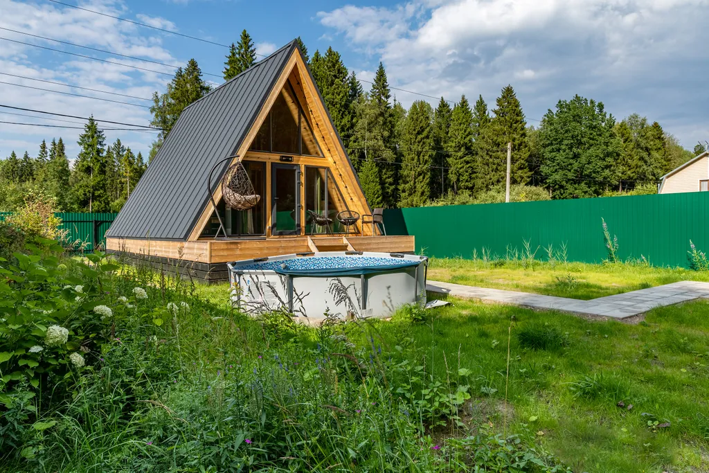 Дом шалаш в окружении леса рядом с озером
