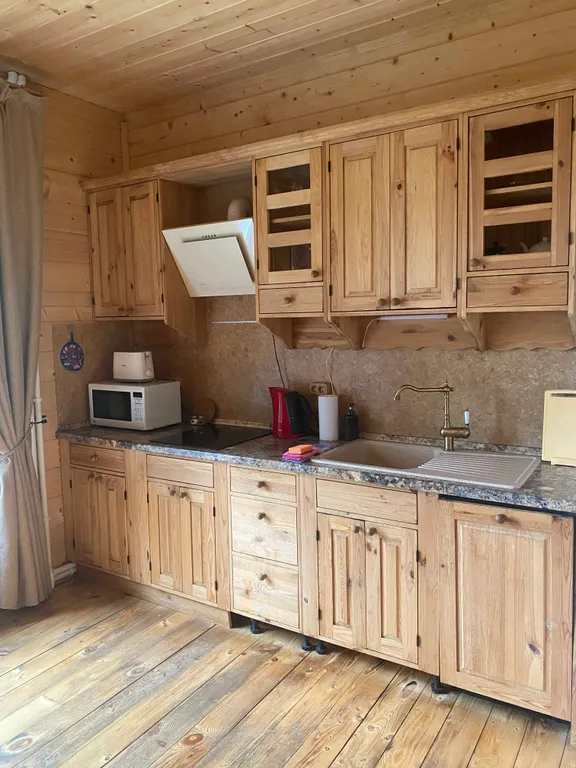 Деревянный дом на берегу реки с беседкой