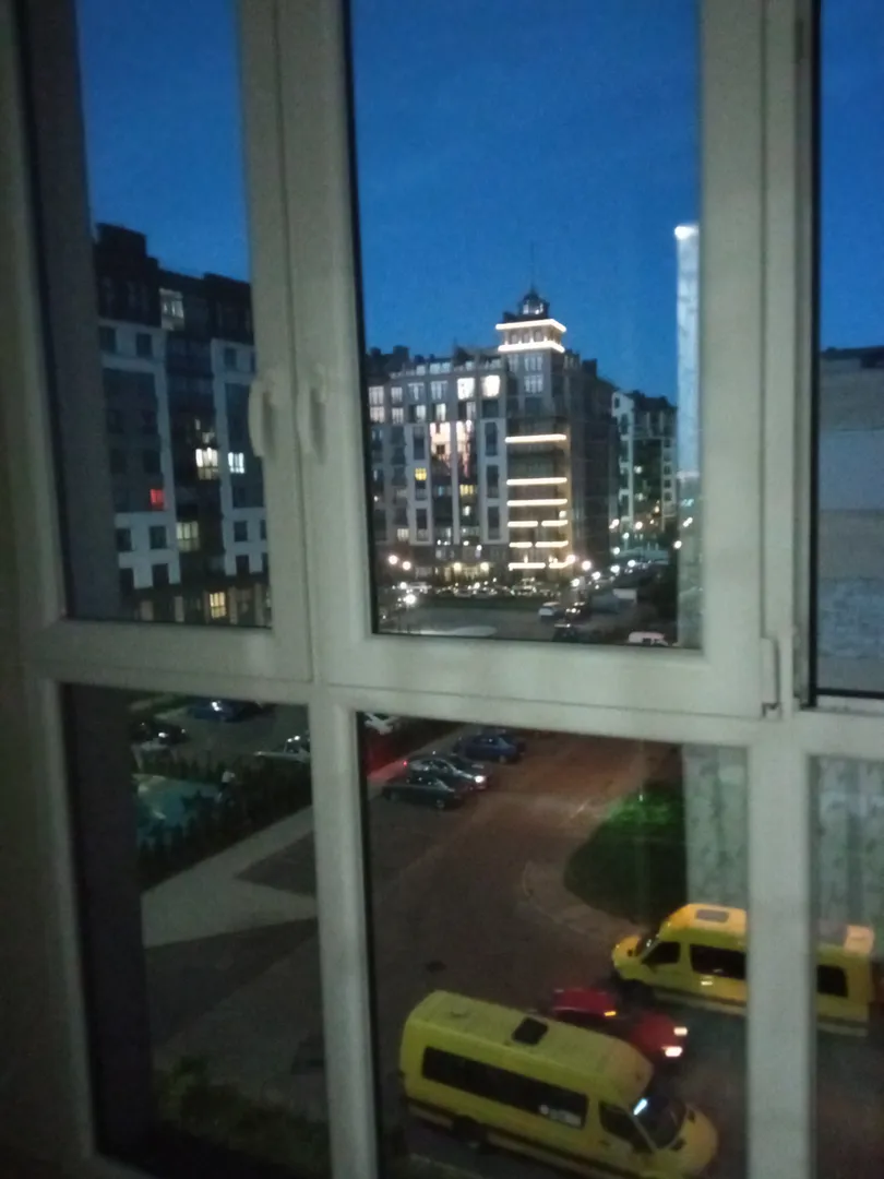 Вид из окна на остановку и соседние дома