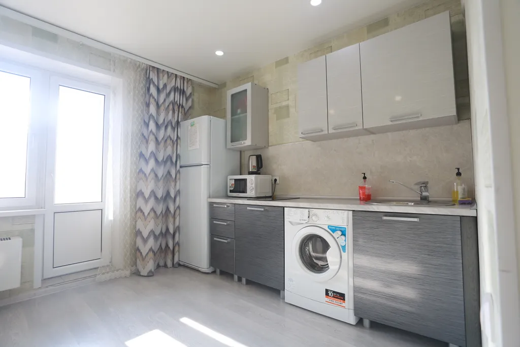 Уютная квартира в стиле лофт с комфортной кроватью и угловым диваном