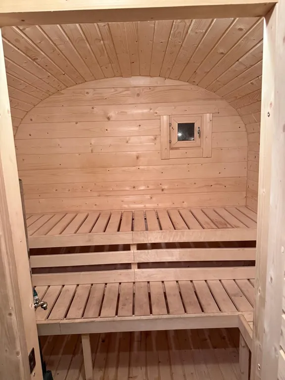 Большой треугольный домик с камином, с ванной у окна с видом на лес