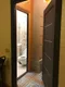 вид из спальной зоны и кухни в коридор с левой дверью с туалетом и душем